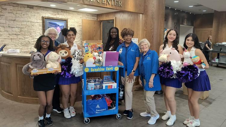 Cheerleaders from University High School gather toys for hospital donation