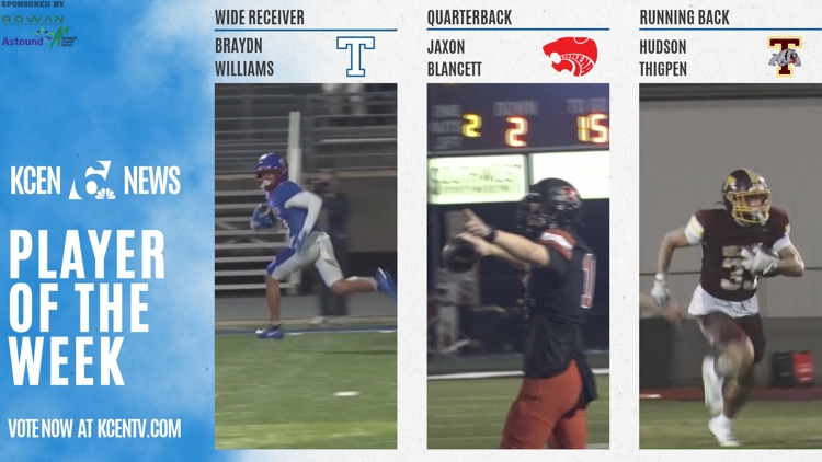 High school football players in action during a game under Friday night lights.
